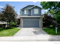Charming two-story home featuring a well-maintained lawn and a spacious two-car garage at 13836 Harrison Dr, Thornton, CO 80602
