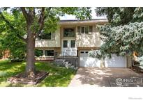Charming two-story home with well-manicured lawn, mature trees and attached two car garage at 1505 Kendall Dr, Boulder, CO 80305