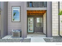 Inviting front entrance with a modern door and updated exterior paint at 1575 W 68Th Ave, Denver, CO 80221