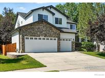 Charming two-story home with a three-car garage and stone facade at 1662 Crestview Ln, Erie, CO 80516