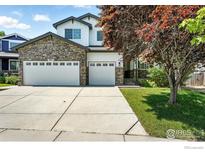 Charming two-story home featuring a stone facade and a spacious three-car garage at 1662 Crestview Ln, Erie, CO 80516