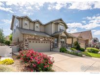 Beautiful two story home with manicured landscaping and a welcoming front porch at 190 Olympia Ave, Longmont, CO 80504