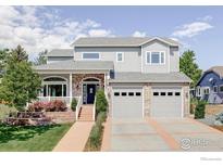 Charming two-story home featuring a brick facade, attached garage, and well-manicured front yard at 2073 Eisenhower Dr, Louisville, CO 80027