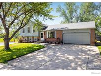 Charming two-story home with well-maintained lawn, mature trees, and a convenient two-car garage at 322 W Harper St, Louisville, CO 80027