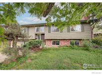 Charming two-story home features a well-maintained lawn, mature trees and brick accents at 3750 Emerson Ave, Boulder, CO 80305
