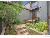 Inviting front entrance with lush landscaping and a charming porch, perfect for welcoming guests at 3880 Telluride Pl, Boulder, CO 80305