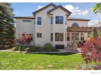 Beautiful home with a pergola covered patio and green lawn at 3931 Stonegrass Pt, Broomfield, CO 80023