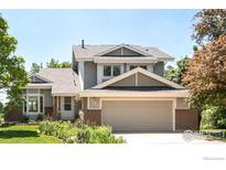Charming two-story home with attached two-car garage, brick accents, and lush landscaping at 4547 Tally Ho Trl, Boulder, CO 80301