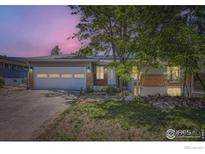 Charming home featuring a well-manicured lawn, brick accents, and a two-car garage at 540 Ithaca Dr, Boulder, CO 80305