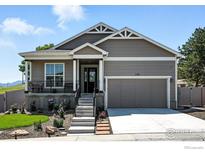 Charming home with a landscaped front yard, covered porch, and an attached two-car garage at 1101 Hillside Ln, Louisville, CO 80027