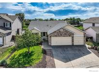 Charming single-Gathering home features a three-car garage, mature tree, and well-maintained lawn at 13586 Raritan St, Westminster, CO 80234