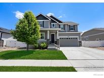 Charming two-story home with landscaped yard, grey siding, and a welcoming front porch at 2332 Tabor St, Berthoud, CO 80513