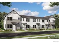 Modern townhome showcasing gray and white siding, well-manicured front yards, and an inviting street view at 2745 Bear Springs Cir, Longmont, CO 80503