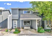 Charming two-story townhome with covered parking and a cozy front entrance with decorative landscaping at 2956 Glenwood Dr, Boulder, CO 80301