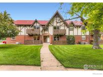 Charming Tudor-style exterior with brick accents, lush lawn, and a welcoming pathway to the front door at 3250 Oneal Cir # 10, Boulder, CO 80301