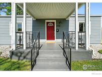 Inviting front entrance with a bright red door and well-maintained landscaping at 4720 Perry St, Denver, CO 80212