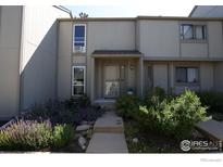 Inviting townhome featuring a landscaped front yard with a walkway to the covered entrance at 4863 W Moorhead Cir, Boulder, CO 80305