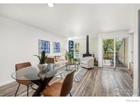 Inviting living room with a cozy fireplace, comfortable seating, and seamless access to the outdoors at 4863 W Moorhead Cir, Boulder, CO 80305