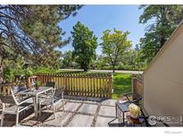 Charming patio area with a table and chairs, perfect for outdoor dining and relaxation with a view of the outdoors at 4863 W Moorhead Cir, Boulder, CO 80305