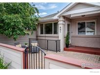 Inviting front entrance with a quaint brick patio and peaceful sitting area surrounded by lush greenery at 651 Ridgeview Dr, Louisville, CO 80027