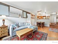 Comfortable living room boasts a sectional sofa, hardwood floors, and an open layout at 854 Walnut St # B, Boulder, CO 80302
