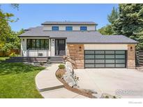 Beautiful modern home with a manicured lawn, stone accents, and a stylish garage door for excellent curb appeal at 950 Quince Ave, Boulder, CO 80304
