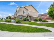 Beautiful two-story townhouse with stone accents and a well-manicured lawn at 12724 Leyden St # E, Thornton, CO 80602