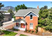 Charming brick home boasts a quaint front porch and lush landscaping at 2025 18Th St, Boulder, CO 80302