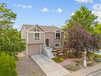 Charming two-story home features a finished garage and beautiful landscaping at 2037 Spencer St, Longmont, CO 80501