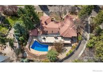 Stunning aerial view of home featuring curved pool, tile patio, and landscaped yard at 2111 E Alameda Ave, Denver, CO 80209