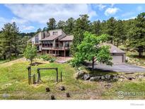 Beautiful two-story home with a well-manicured lawn, mature trees and an oversized two car garage at 2794 Linden Dr, Boulder, CO 80304