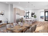 Open concept kitchen features stainless steel appliances, pendant lighting and breakfast bar seating at 300 Shining Star Trl # A, Boulder, CO 80302