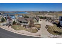 Stunning aerial view of a charming single Gathering home on a large lot with nearby lake at 3545 Cottonwood Cir, Frederick, CO 80504