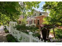 Charming brick home with inviting front porch and lush landscaping, creating a warm and welcoming curb appeal at 512 Marine St, Boulder, CO 80302