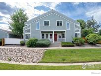 Charming home featuring unique architectural windows and a well-manicured lawn at 5190 Buckingham Rd, Boulder, CO 80301