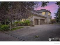 Stucco home featuring a driveway with a 2-car garage at 714 Skywalker Pt, Lafayette, CO 80026