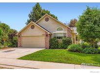 Charming single-Gathering home features a well-manicured lawn, two car garage, and inviting curb appeal at 7196 Christopher Ct, Niwot, CO 80503