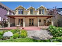 Stunning home featuring a covered back deck and beautifully landscaped backyard at 832 Neon Forest Cir, Longmont, CO 80504