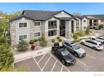 Modern apartment building with stone accents and manicured landscaping, conveniently located near parking at 875 E 78Th Ave # 53, Denver, CO 80229