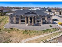 Well maintained two-story exterior featuring stone accents and a landscaped yard at 875 E 78Th Ave # 70, Denver, CO 80229