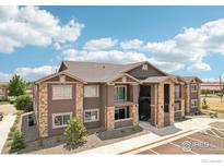 Attractive multi-story apartment building with stone accents and well-maintained landscaping at 875 E 78Th Ave # 72, Denver, CO 80229
