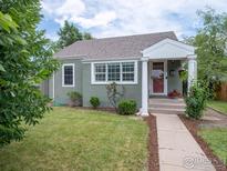 Charming single-story home with a well-manicured lawn and inviting front porch at 1750 Trenton St, Denver, CO 80220
