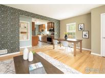 Open-concept living and dining area with hardwood floors and ample natural light at 1750 Trenton St, Denver, CO 80220