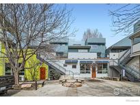 Unique modern condo building with colorful exteriors, courtyard, and architectural stairs at 2018 Ionosphere St # 3, Longmont, CO 80504
