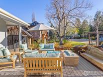 Inviting outdoor patio featuring a fire pit, comfortable seating, and a beautifully landscaped yard at 2942 4Th St, Boulder, CO 80304