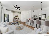 Contemporary living room featuring an open floorplan, sleek modern kitchen, and stylish decor at 3100 Huron St # 1D, Denver, CO 80202
