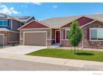 Charming single-Gathering home with a well-manicured lawn, neutral paint, stone accents, and a two-car garage at 11129 Paradise Ln, Firestone, CO 80504