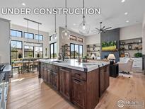 Spacious open-concept kitchen features a large island, and stainless steel appliances at 1255 Eliza Ave, Berthoud, CO 80513
