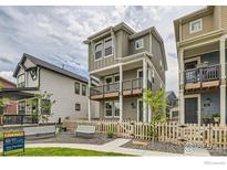 Charming two-story home with a cozy front patio and a quaint picket fence at 128 E Douglas St, Superior, CO 80027