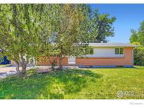 Charming single-story home featuring brick accents and a well-maintained front lawn at 131 E 15Th Ave, Longmont, CO 80504